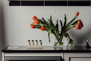 Kitchen bench with orange tulips and fragrance oils