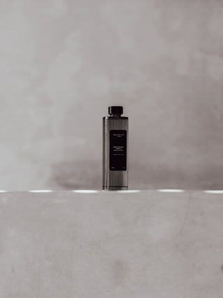 kirri fragrance oil refill on a concrete ledge
