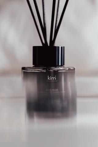 kirri reed diffuser with black reeds in soft light